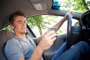 Teen is texting while driving.